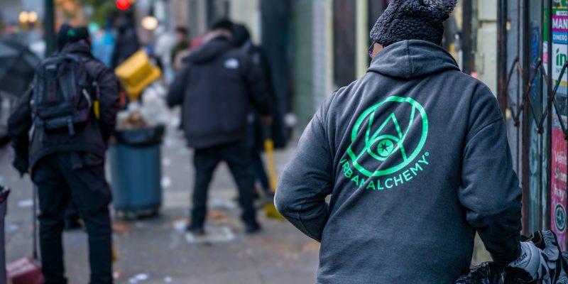 Urban Alchemy Practitioner Cleaning Street